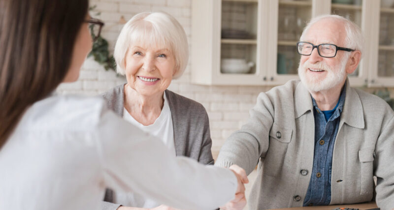 An elderly couple speaking to an advisor about the NHS CHC Funding process